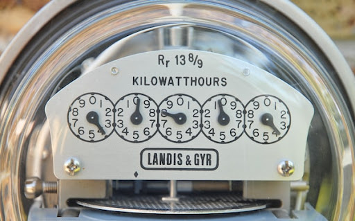 A power meter tracks reduced energy usage after a new furnace installation.